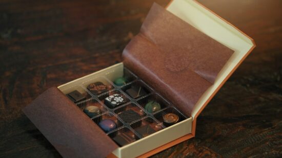 Box of gourmet chocolates sitting on a table